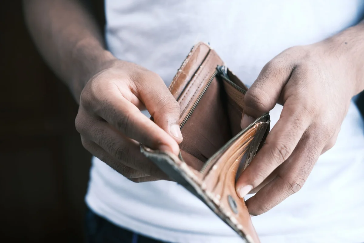 Person holding an empty open wallet