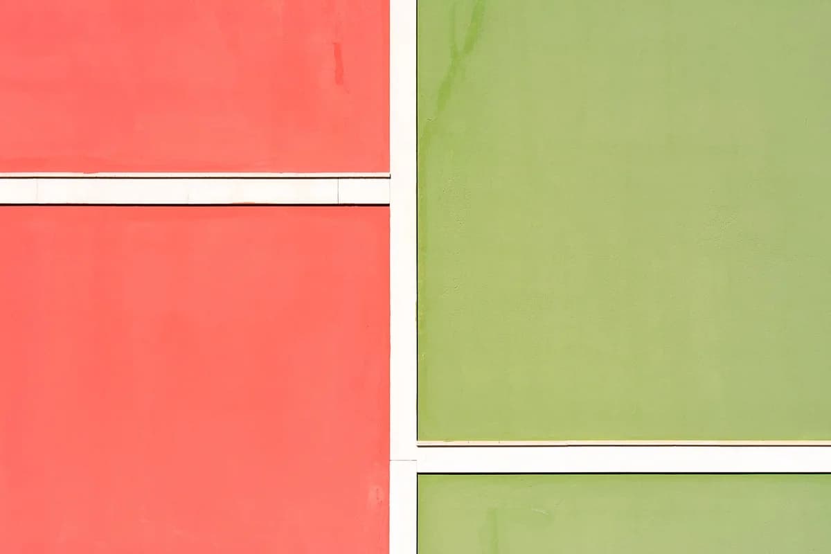 Colorful facade with red and green panels creating a minimalist architectural design.