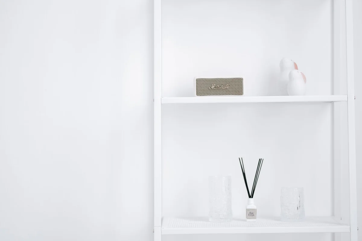 A neat white shelf with decorative items, displaying minimalistic interior style.