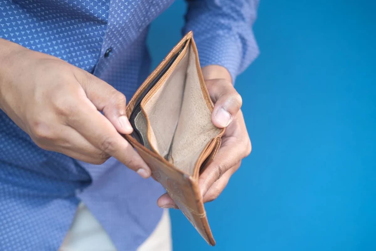 Person holding an open empty wallet