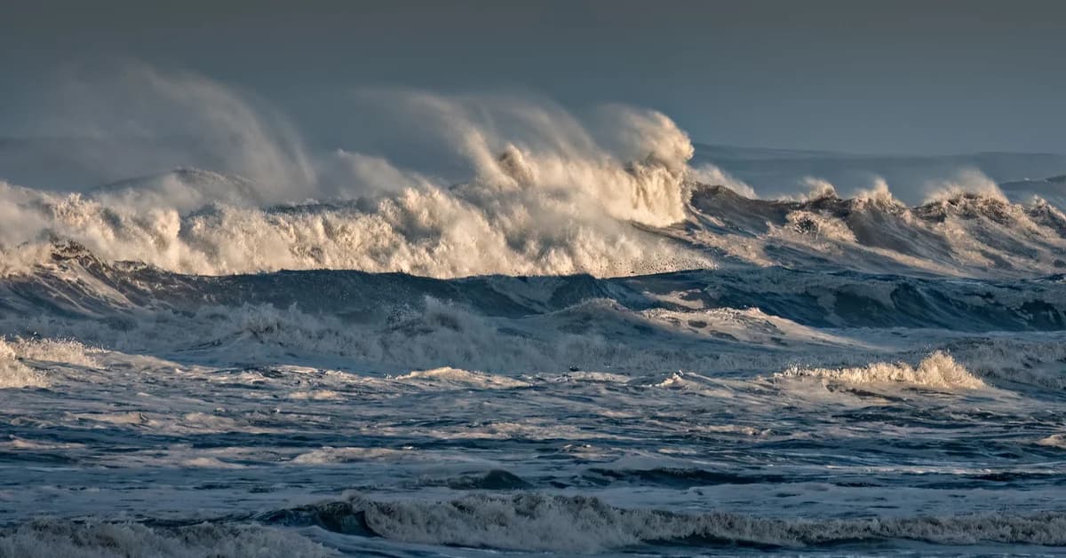Powerful ocean waves crashing with foam and spray, capturing dramatic sea motion.