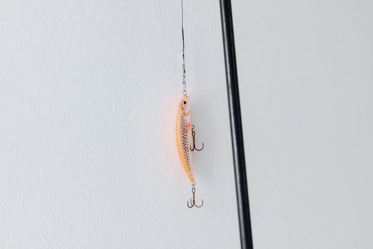 Detailed close-up of a fishing lure attached to a fishing rod, perfect for angling or fishing enthusiasts.