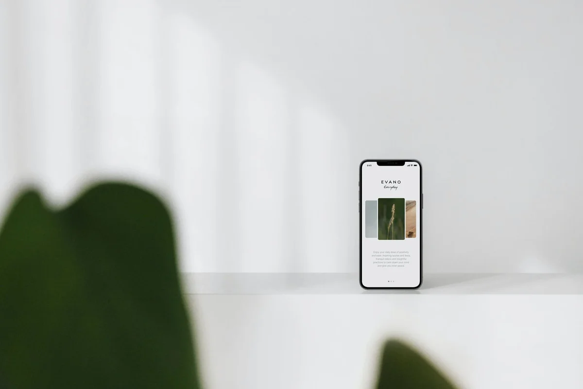 A modern smartphone displaying content, placed on a sleek white surface.